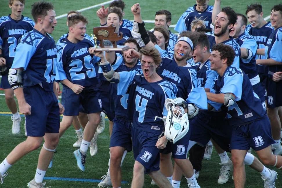 Dracut athletes celebrating a championship