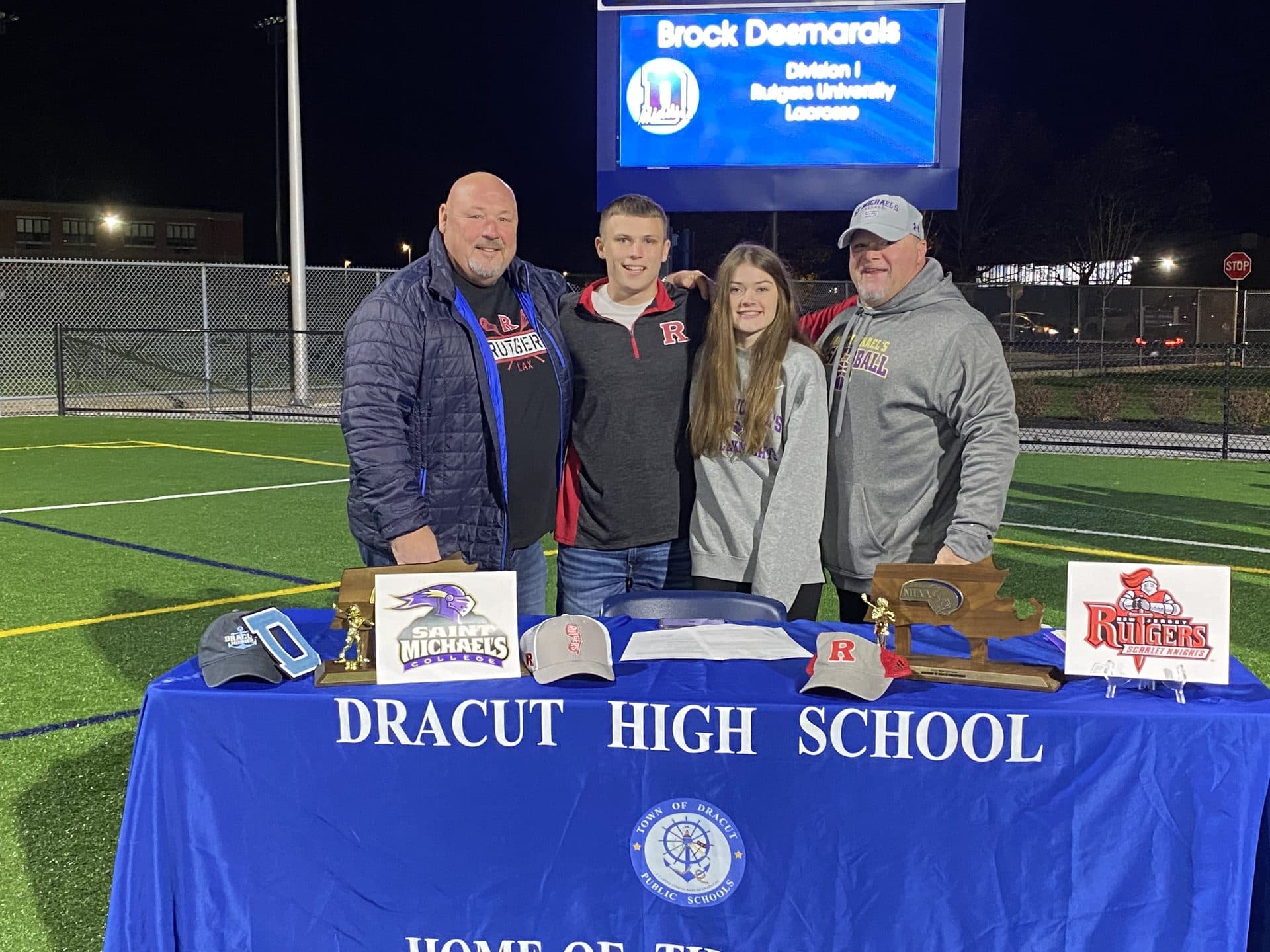 Dracut Middies athlete and family celebrating a college signing