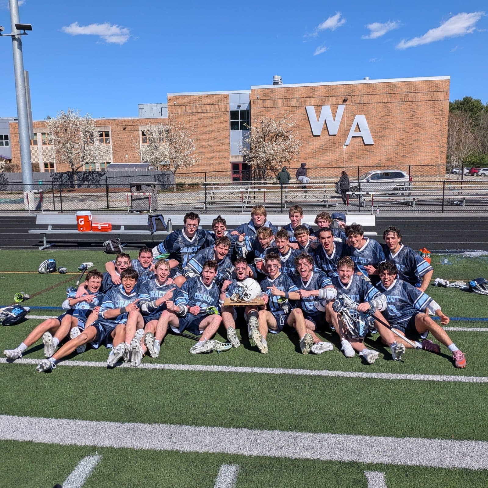 Dracut team celebrating with the trophy